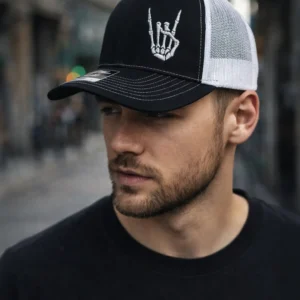 Black and white trucker hat with embroidered rocker hand
